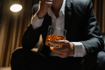 Businessman wearing a suit whiskey glass of liquor.