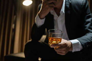 Businessman wearing a suit whiskey glass of liquor.
