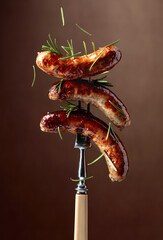 Grilled Bavarian sausages with rosemary. - obrazy, fototapety, plakaty