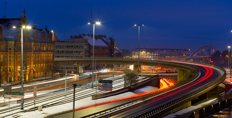 Obraz premium 2022-12-09; evening road with smeared traces of cars Gdansk Poland