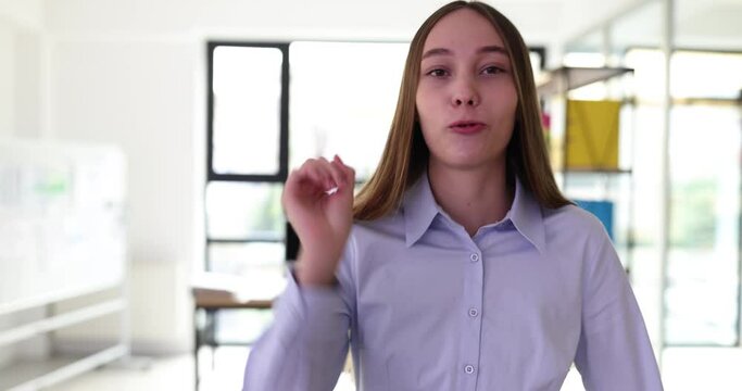 Business woman talks directly to camera walking around office. Confident successful strict businesswoman blogger speaks to camera