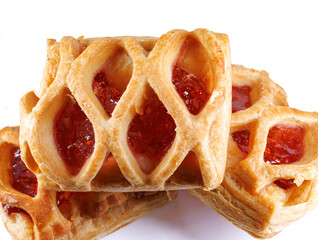 Puff pastry pastry with lingonberry jam on a white background. Cookies with lingonberry jam.