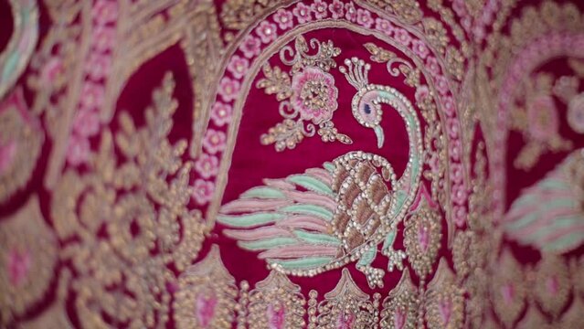 This mesmerizing video displays a wedding bride's choli design adorned with intricate peacock motifs, blending elegance and tradition in her bridal ensemble.