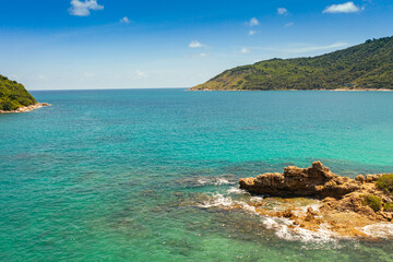 Fototapeta premium .aerial view around mini isle in front Ya Nui beach. .The clear green sea water can be seen through the sea..green sea white sand beach 4K video for creative nature and travel concept.