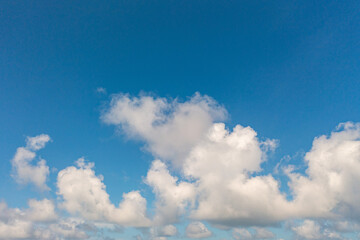 .The sky was a brilliant blue, dotted with white clouds that moved gracefully across the...