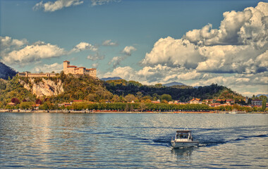 A small boat on Lake Maggiore in front of the Angera fortress.