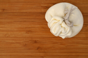 Creamy Italian traditional Burrata cheese on wooden board