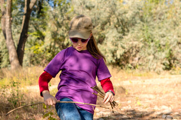 Child collects brushwood during hike