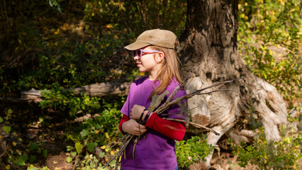 Child collects brushwood during hike