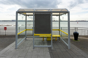 A bus stop is located in the background of the beach.