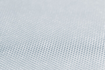 Abstract background of a stainless steel perforated sheet. Full frame