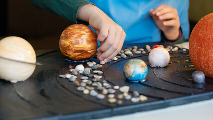 Child's Hands Designing Solar System