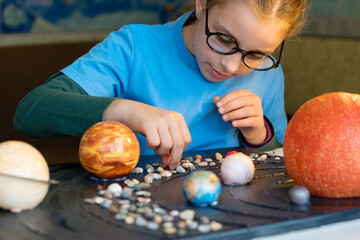 Focused Girl Crafting a Cosmic Display © Vagengeim