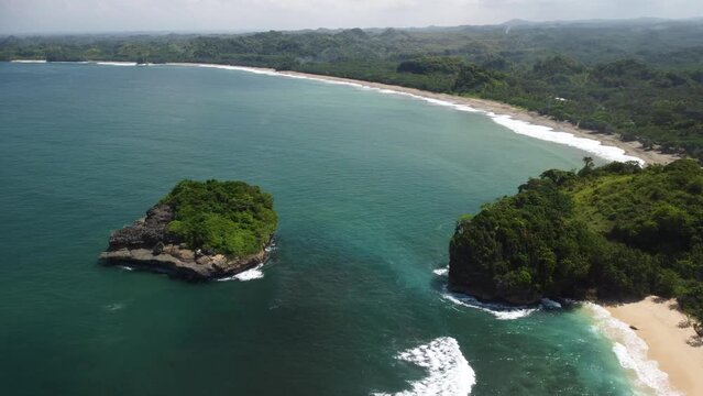 The view behind Tanjung Penyu Mas Beach is a very wide expanse of ocean with a very long beach