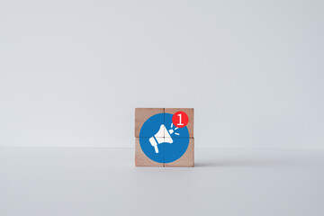 Megaphone with new notification icon on wooden cubes over white background idea for advertising,announce promotion,online marketing,notification.