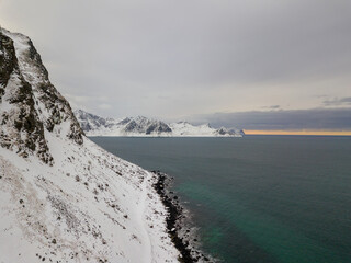 Aerial drone panoramic view of amazing Lofoten Islands, Norway. Mountains and sea top view during sunset. Natural landscape at the Winter scenery in scandinavia.
