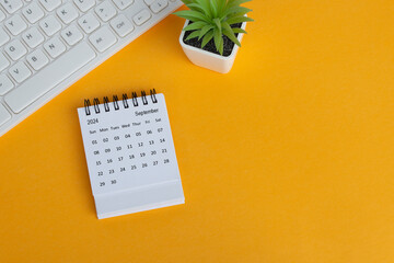 September 2024 desk calendar on yellow background. Directly above. Flat lay.
