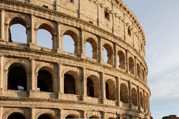 colosseum, historical building in close up with arches and blue sky in Rome, Italy