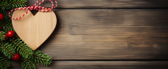 Festive wooden heart ornament on rustic background with pine branches and berries. Christmas and New Year concept. Design for holiday greeting card, banner with copy space for text - obrazy, fototapety, plakaty