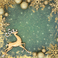 Christmas gold reindeer and sparkling bauble north pole theme on grunge green background. Merry...