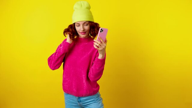 Selfie, pose and fashionable hipster woman with phone, peace sign for social media post. Lady with mobile smartphone posing, taking profile picture, trendy makeup, outfit, studio yellow background