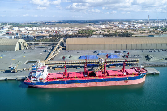 Huelva, Spain - October 21, 2023: Aerial drone view of CL FUZHOU HE, a Bulk Carrier that was built in 2021and is sailing under the flag of Liberia. Moored in the industrial outer port of Huelva