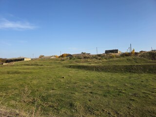 A grassy field with a building in the distance