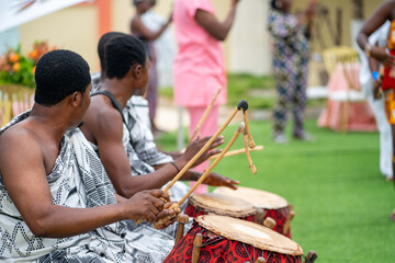 unidentified african musical group outdoor- black guys drumming traditional instrument outdoor - obrazy, fototapety, plakaty