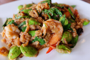 Delicious spicy Stir Fried bitter beans with Shrimp on white plate