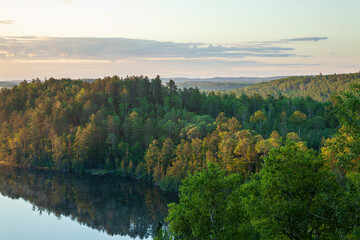 Fototapeta na wymiar Trees on hills at dawn by a lake near the Gunflint Trail in northern Minnesota during summer