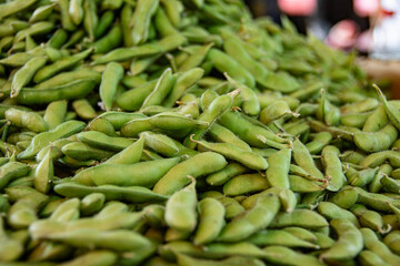 A large pile of fresh edamame