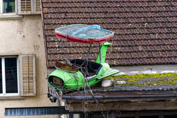 Green wrecked vehicle of fair ride at industrial district of Swiss City of Zürich on a cloudy autumn day. Photo taken October 21st, 2023, Zurich, Switzerland.