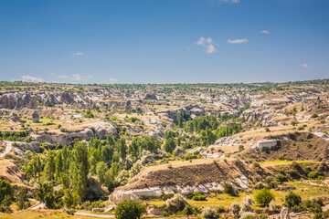 Rocky landscape in Cappadocia, Turkey. Travel in Cappadocia. Unusual semi-desert mountain ranges. Amazing Rocky summer landscape in Cappadocia Goreme