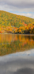 Fototapeta na wymiar Autumn landscapes near a lake in Canada in the province of Quebec