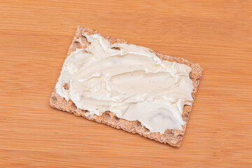 Whole Grain Crispbread with Cream Cheese on Bamboo Cutting Board. Quick and Healthy Sandwiches....