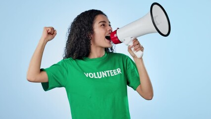 Woman, volunteer voice and megaphone for protest, support and call to action or speech in studio. Face of person speaking, volunteering in NGO tshirt for change, attention or fight on blue background