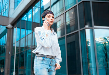 Fototapeta premium Portrait of a young woman talking on her mobile to her boyfriend about ending their relationship