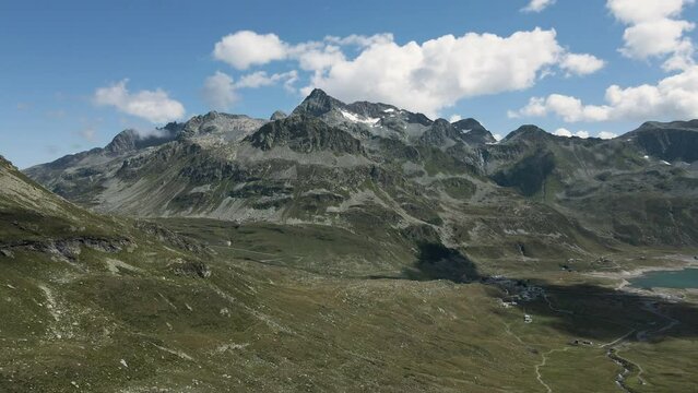 Aerial view of Val Loga - Zooming out from Montespluga Lake Town and Pizzo Suretta