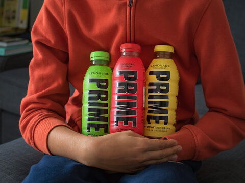 Slovenia, Ljubljana - 21 October 2023: Boy teenager holding Prime Hydration drink