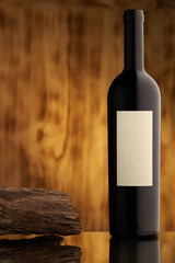 Wine bottle with white blank label on black wooden rustic background with copy space. Nobody.