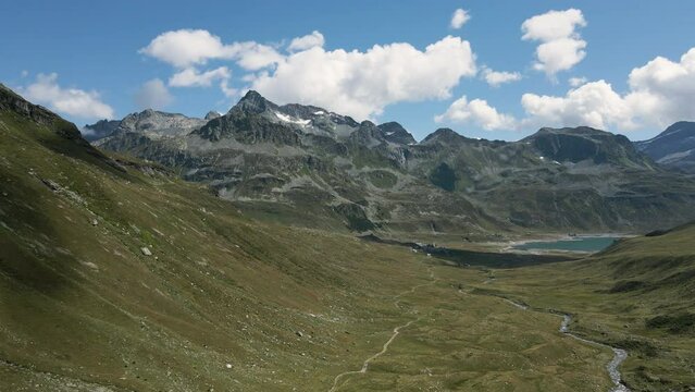 Aerial view of Val Loga - Approaching Montespluga Lake Town and Pizzo Suretta