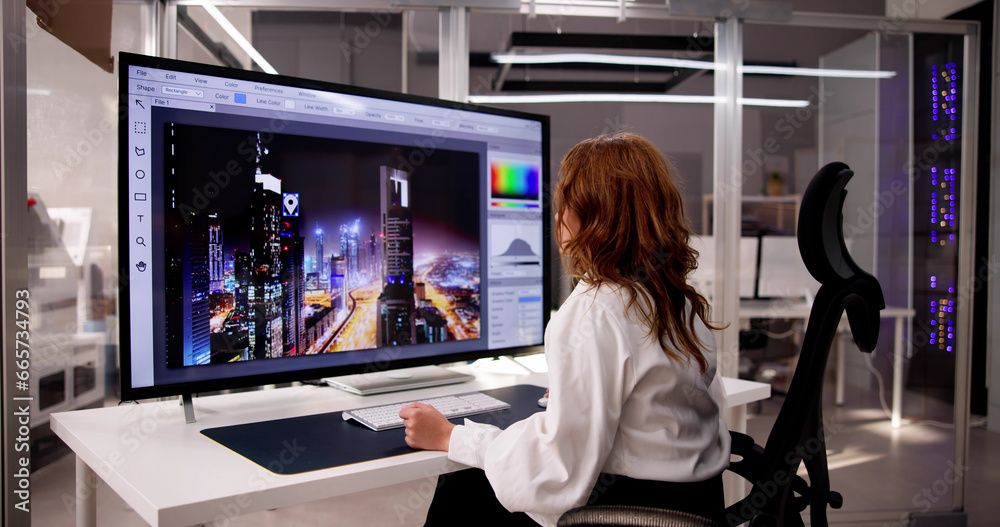 Poster Designer Editing Photo On Computer