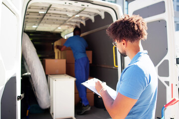 Movers Checking Delivery Boxes