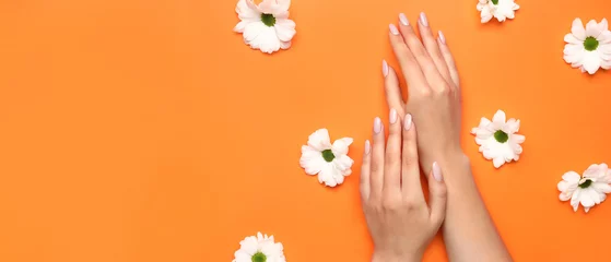 Foto op Plexiglas Female hands with beautiful manicure and flowers on orange background with space for text © Pixel-Shot