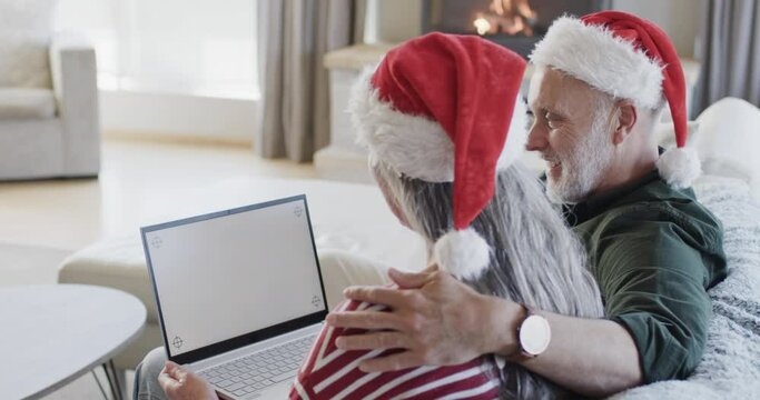 Middle Aged Caucasian Couple With Laptop With Blank Screen At Christmas At Home, Slow Motion