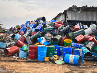 Pile of discarded barrels at a junkyard