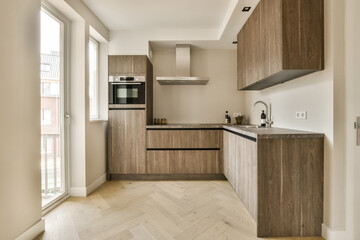 a modern kitchen with wood cabinets and white marble countertops in the room is very clean, but it's not too