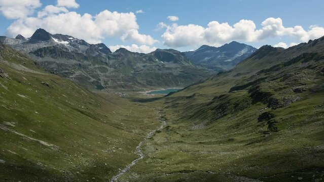 Drone flying in Val Loga - View on Montespluga Lake Town and Pizzo Suretta
