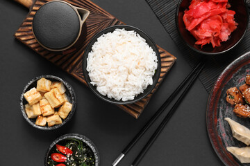 Composition with different Chinese dishes on dark background