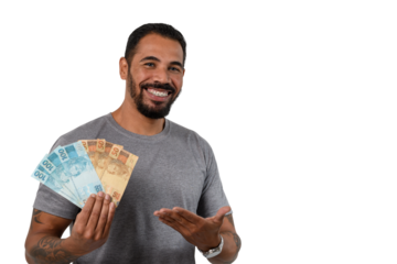 Man points to the Brazilian money in his hand, smiling, positive emotion